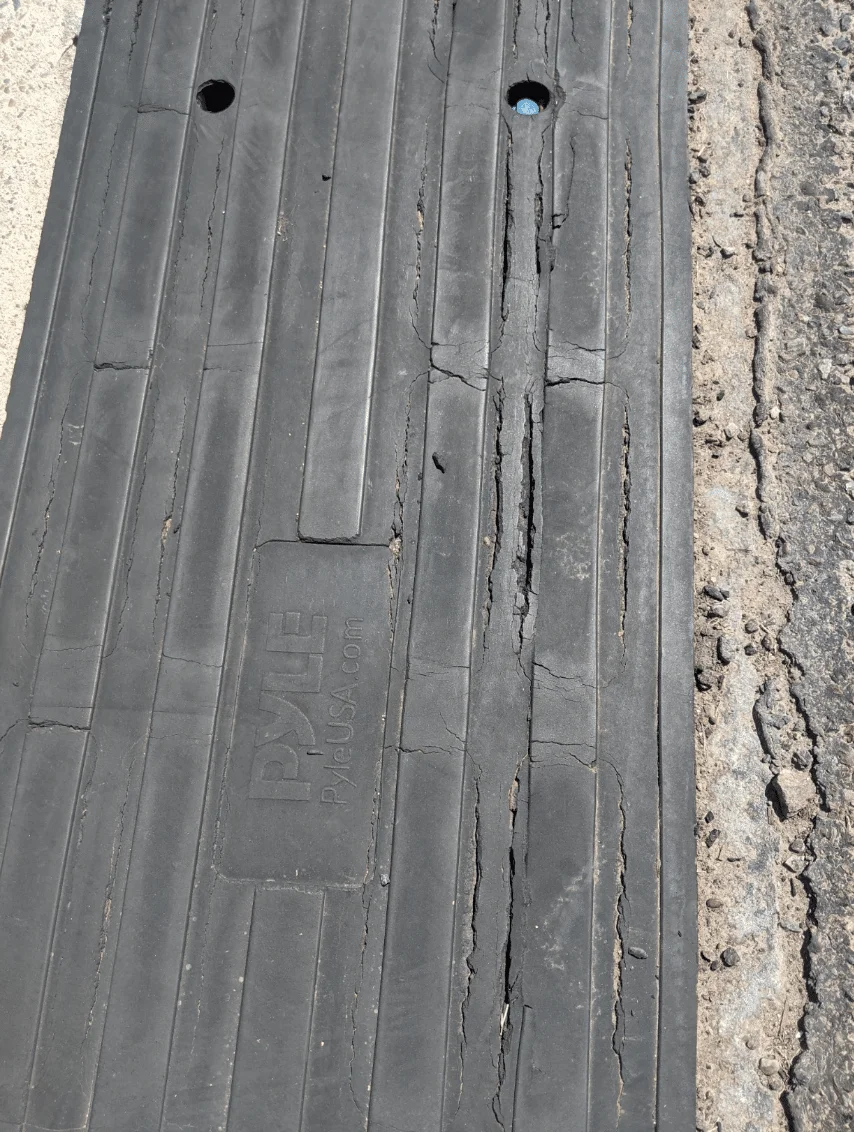 Damaged Pyle Curb Ramp that has been placed at end of driveway.