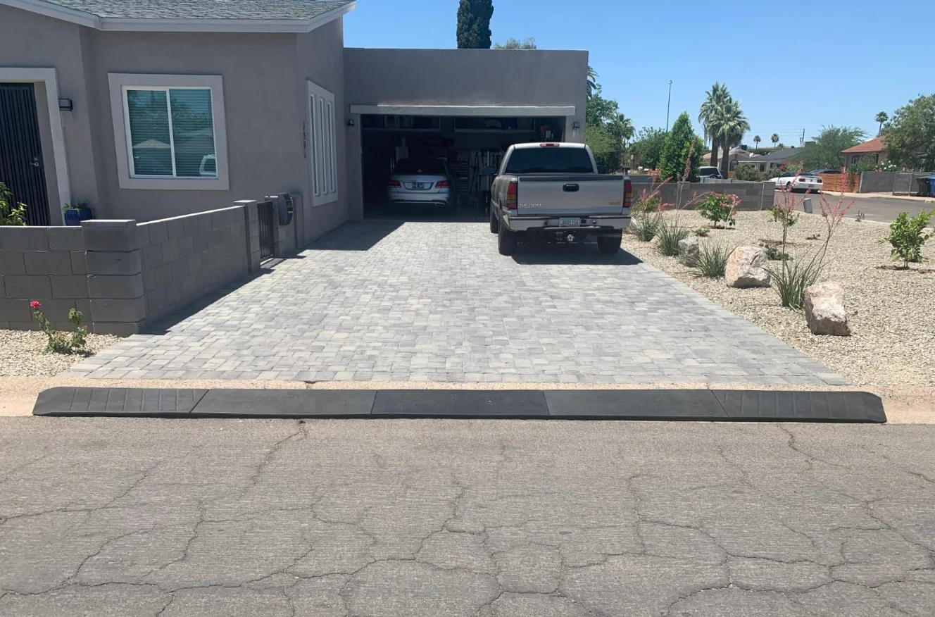 An image of a sturdy and durable driveway curb ramp with a weight capacity of 35,000lbs and suitable for various sizes of vehicles.