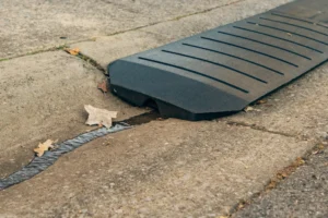 The Smooth Curb driveway curb ramp with water flowing underneath